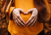 Food Poisoning while Pregnant lady in orange shirt
