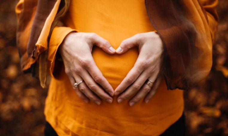 Food Poisoning while Pregnant lady in orange shirt